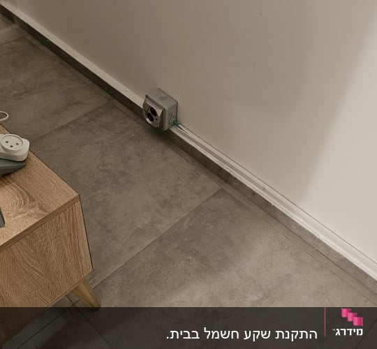 שקע חשמל על הקיר עם כבל מחובר